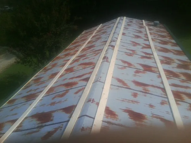 Rusted metal roof panels with new wood purlins before replacement — Storm Damage Roof Repair in Dunnellon by Roofing Brothers